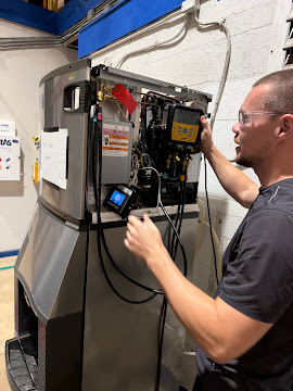 Certified Express Xpert appliance repair technician using a multimeter and factory diagnostic tools to inspect a control board during a same-day service call in South Florida