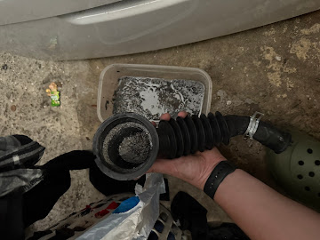 Dishwasher drain hose and filter caked with calcium and hard-water mineral deposits removed during an Express Xpert dishwasher repair in Coral Gables, Miami-Dade County, FL