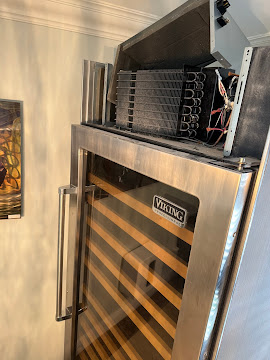 Viking built-in wine cooler refrigeration system with the condenser coil and sealed system exposed during an Express Xpert refrigerator repair in Boca Raton, Palm Beach County, FL