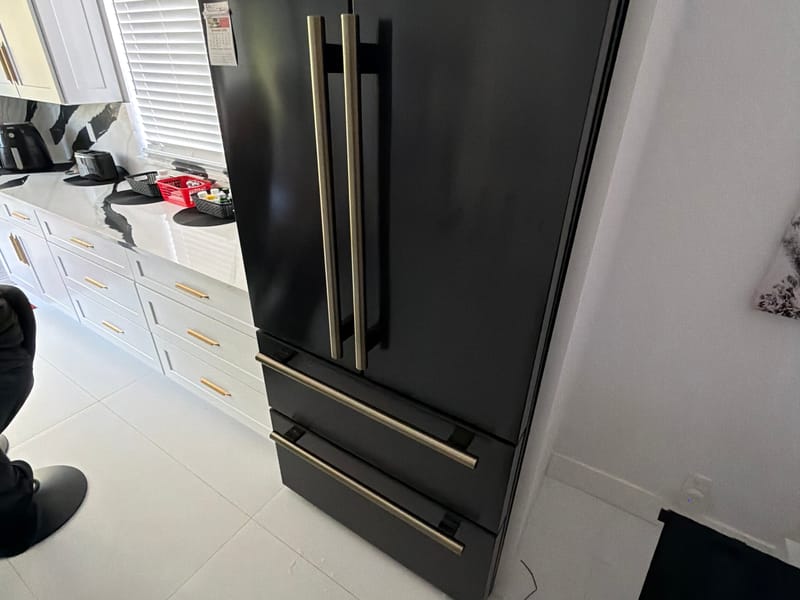 Express Xpert technician servicing a refrigerator in a Miami-Dade home